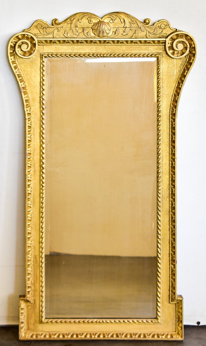GOLD GILTWOOD GESSO PIER MIRROR: This mirror is made of a wood frame with gesso sculpted details on top. This is a reproduction made in the mid 20th century to emanate the early designed pieces. The mirror measures approx. 48" H x