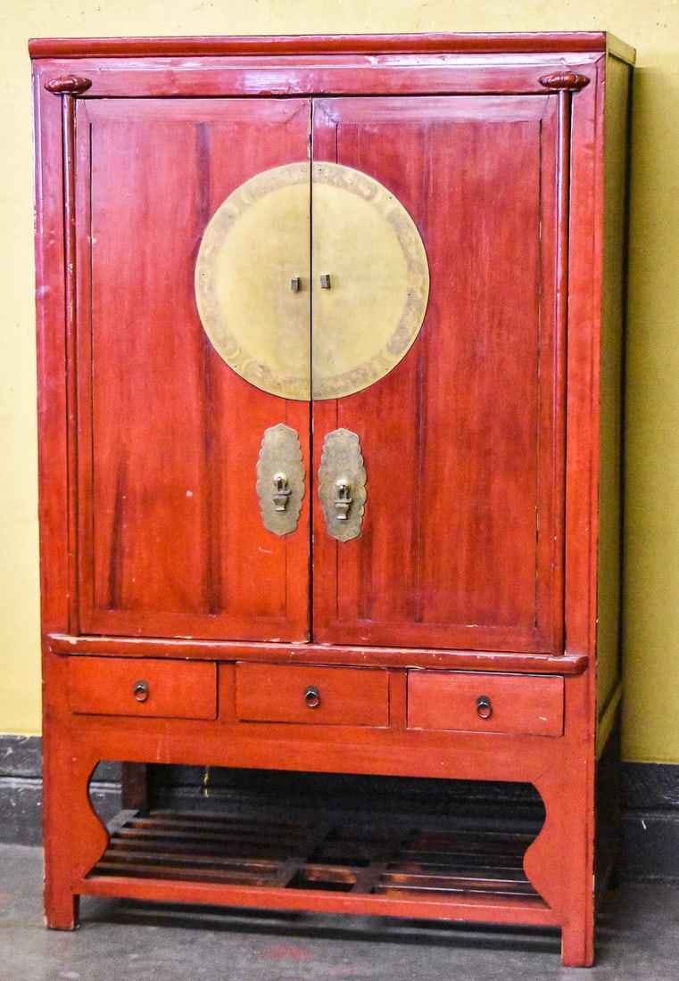 CHINESE ELMWOOD RED WEDDING CABINET: A Chinese elmwood red lacquer wedding cabinet, early 20th century. The cabinet measures approximately 70" H x 44" W x 22.5" D.