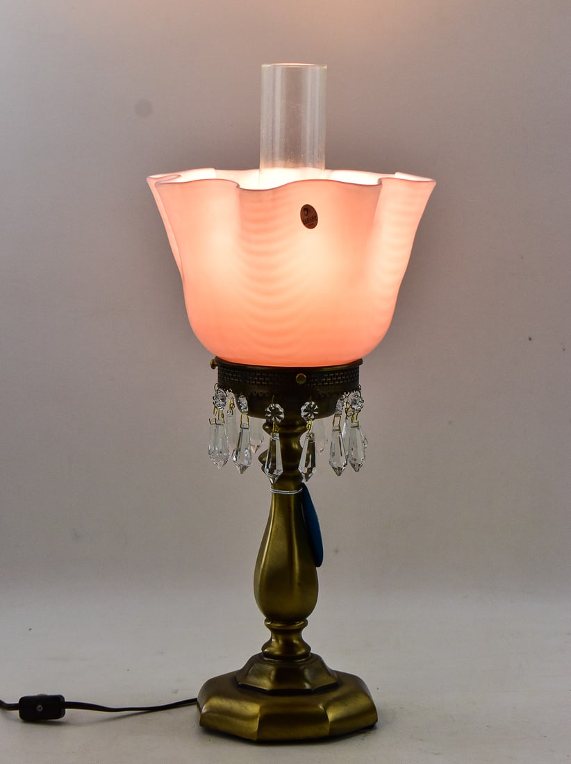 FENTON LILAC OVERLAY DRAPERY HANDKERCHEIF LAMP: This electric lamp has an eight point handkerchief rim with 13 dangle prisms. Comes with hurricane chimney and antiqued brass base. This lamp was release by Fenton Glass circa 1990s and measures