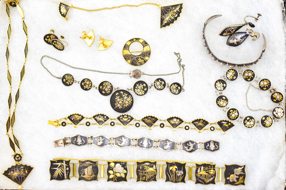 JAPANESE DAMASCENE JEWELRY ASSORTMENT: This collection has twelve pieces in it. Each piece has a small work of art on each panel. Two pieces are marked sterling weighing 29.3 grams. Lot includes three pairs of earrings(two screw back, one 