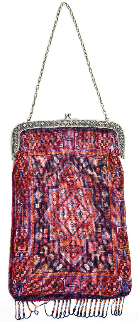 MIRCO BEADED PERSIAN RUG DESIGNED EVENING BAG: This bag has a Persian rug design made of hundreds to thousands of micro glass beads. The clasp is silver in color and the lining is silk. The purse measures approximately 12.5" H x 8" W x 0.5" D.
