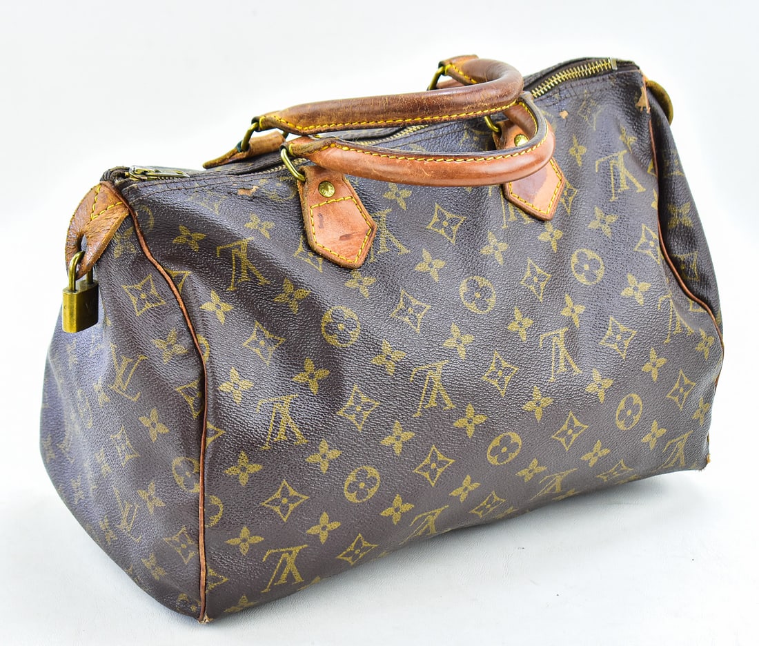 VINTAGE LOUIS VUITTON "SPEEDY" MONOGRAM HANDBAG: A vintage circa 1980s-1990s Louis Vuitton "Speedy 30" coated canvas monogrammed satchel handbag with leather handles and trim. The bag measures approx. 8.5"H x 13"W x 7.5"D.