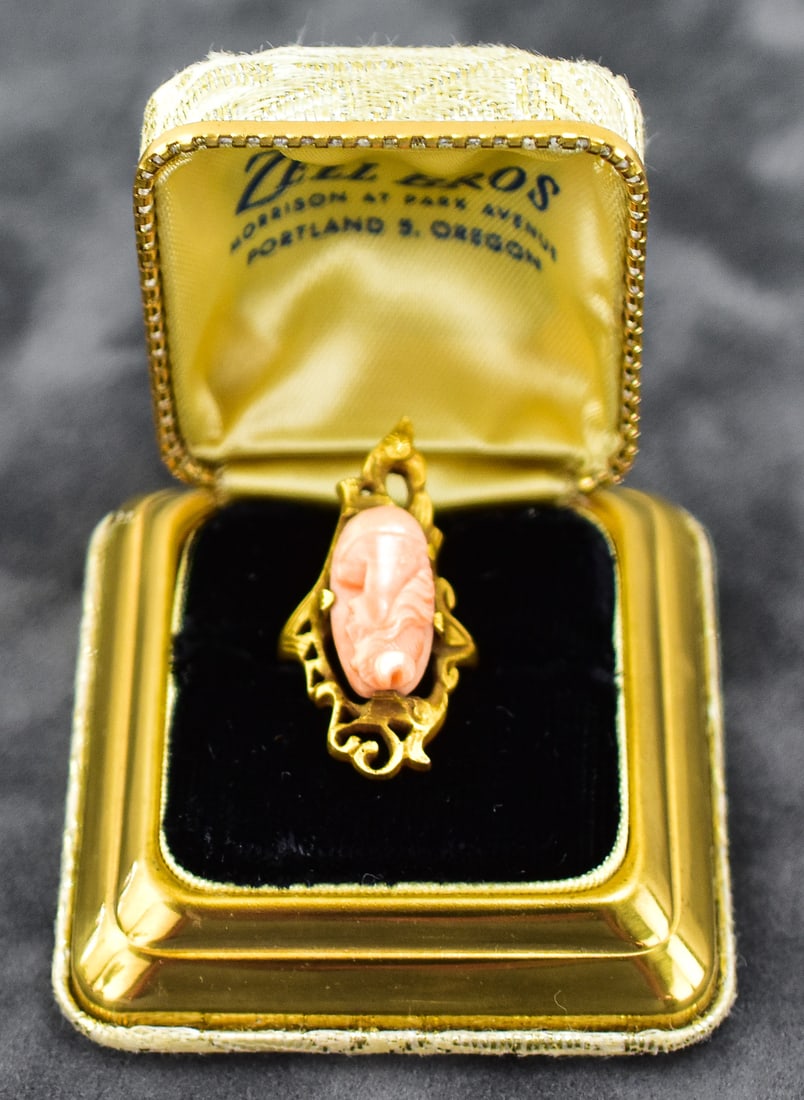 ART NOUVEAU 14KT GOLD CARVED ANGEL SKIN CORAL CAMEO: Ring size is 5.5. Ring is made of 14kt with a hand carved coral cameo. Ring measures approx. 1" H x 0.5" W x 1.5" D.