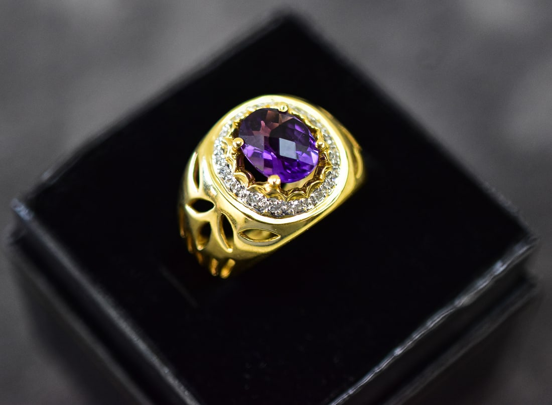 14KT GOLD AMETHYST BISHOP RING: Ring size is 6. Ring is made of 14kt yellow gold with a large purple amethyst and 16 diamonds. Ring measures approx. 1" H x 0.5" W x 0.5" D.