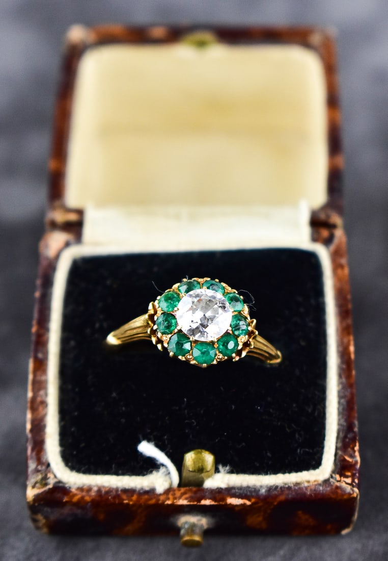 14KT GOLD DIAMOND & EMERALD HALO CLUSTER RING: The ring is a size 8. 14kt band with large diamond and 9 emeralds. Ring measures approximately 1" H x 1" W x 0.5" D.