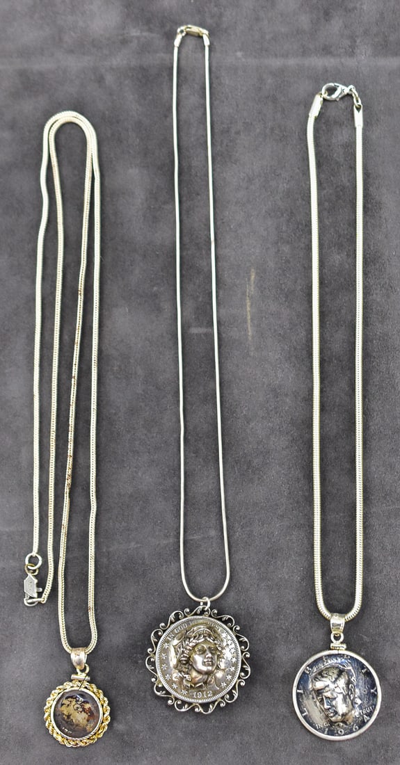 TRIO OF COIN PENDANT NECKLACES; STERLING SILVER: This trio has three necklaces with sterling silver necklaces. Lot has a total of 55 grams of sterling. Pendant one is a 1981 Roosevelt dime. Pendant two is a 1964 John F. Kennedy 50 cent piece that
