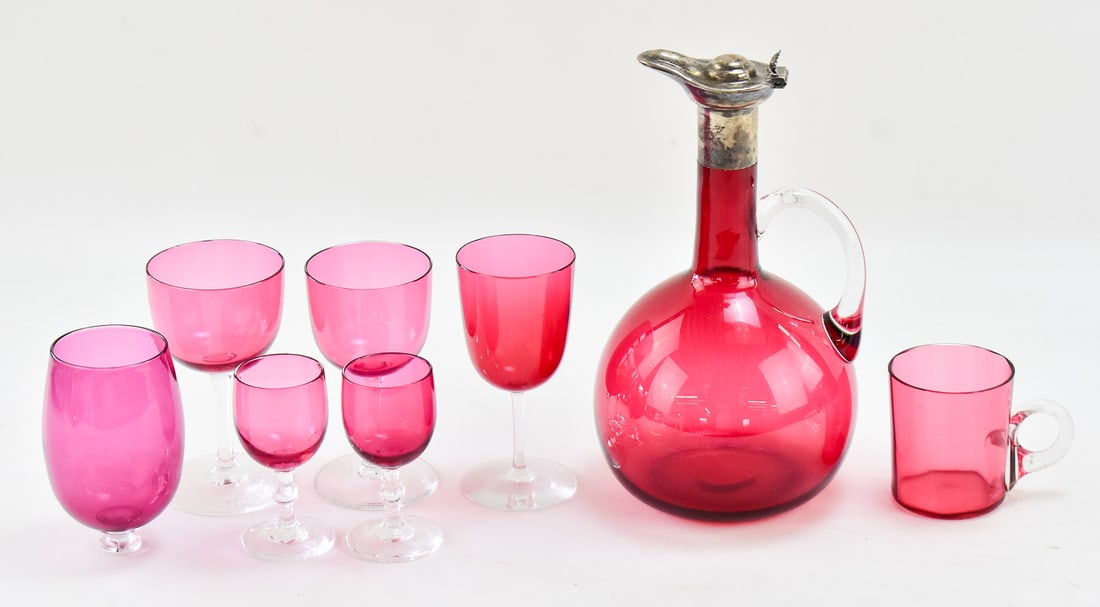 ENGLISH CRANBERRY GLASS DECANTER W/ STERLING SPOUT, EUSTACE G. PARKER 1899, & CRANBERRY GLASSES: An 1899 cranberry glass decanter with a sterling silver spout made hallmarked by Eustace G. Parker in 1899, and an assortment of wine glasses, cocktail glasses and mug made of cranberry glass with cle