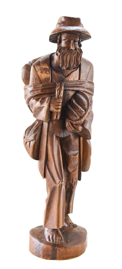 GERMAN BLACK FOREST HAND-CARVED WOOD SCULPTURE: A German Black Forest hand-carved wooden folk art sculpture of a bearded traveler or European vagabond. The wood sculpture measures approx. 32" H x 9.5" W x 9.5" D.