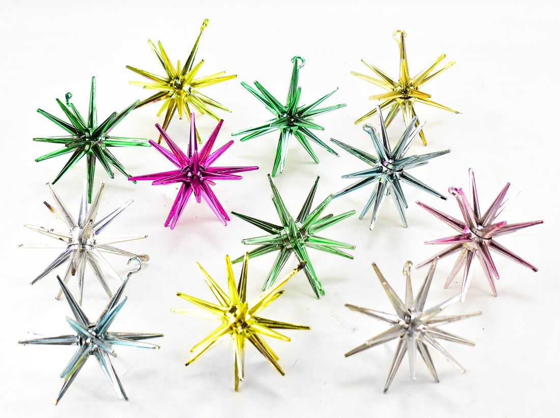 ATOMIC STARBURT "SPUTNIK" CHRISTMAS ORNAMENTS: This collection has 12 starburst ornaments. Each one is painted metallic over black plastic. These date back to the mid 1950s. All of them approx. measures 5" H x 4" W x 4" D.