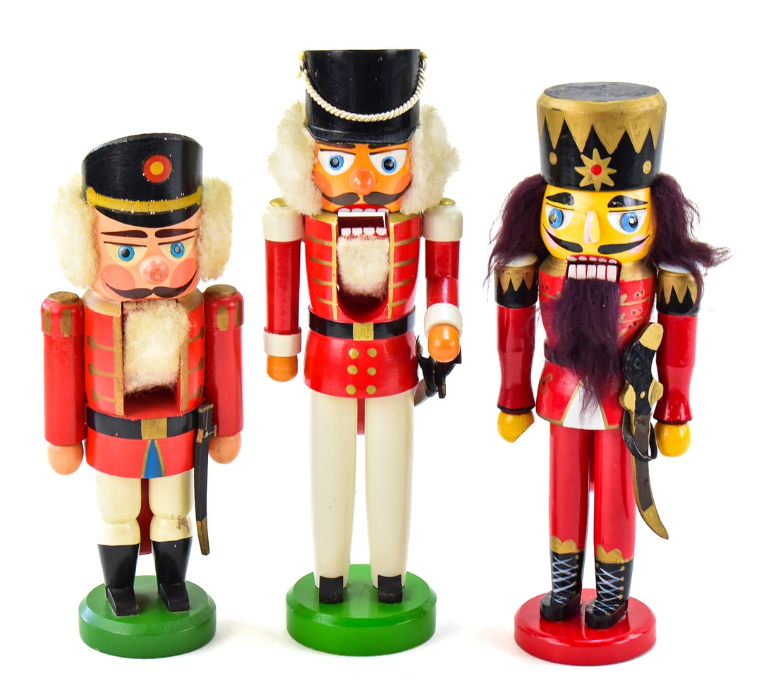 TRIO OF GERMAN ERZEGEBIRGE & ULLMAN GMBH WOODEN NUTCRACKERS: Trio of German wooden nutcrackers made by Erzegebirge and Ullman Gmbh. They each measure approx. 11" H x 3" W x 3" D.