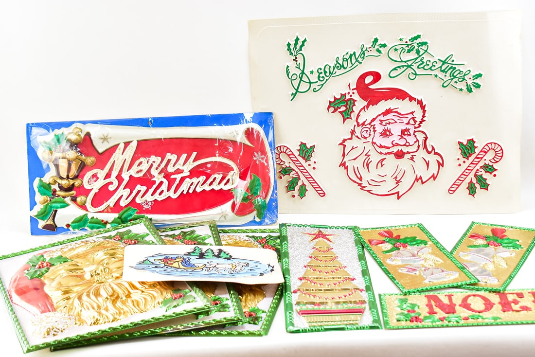 VACUFORMED CHRISTMAS SIGN COLLECTION: This lot includes 11 signs. 8 of them are from the artist Kurt S. Adler circa 1970s. The remaining three are generic Christmas wall or window decor from 1950-1970s. The largest sign measures