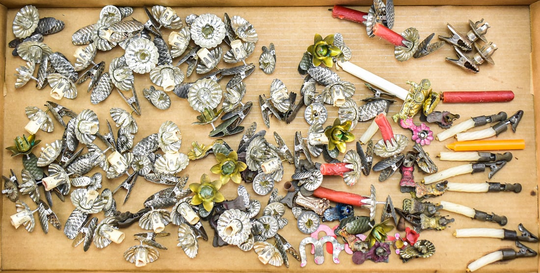 TIN CLIP ON CHRISTMAS TREE CANDLE HOLDERS: This collection has approximately 110 tree clips and 16 candles. All the clips are different shapes, sizes and colors. A single holder measures approximately 4" H x 2" W x 1.5" D.