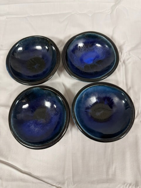 Ceramic Bowls: Lot of four (4) handmade ceramic serving bowls with a deep blue and black glazed finish. Bowl features a glssy glaze that shifts between shades of dark blue and black. 3.34"