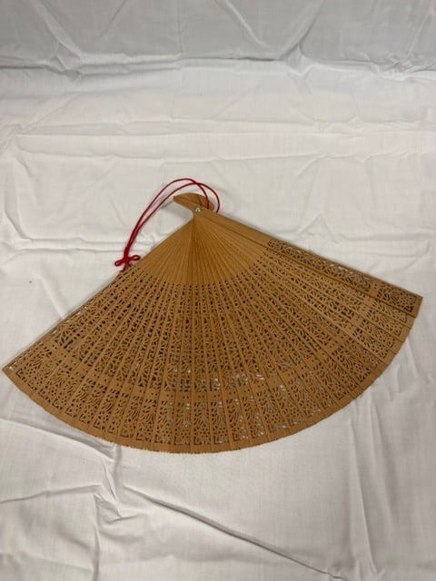 Japanese Fan: Tradtional Chinese sandalwood folding hand fan with intricate carved patterns and a red tassel
