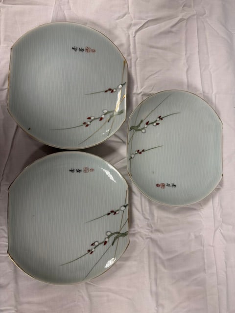 Porcelain Plates: Set of three (3), 7' Japanese porcelain plates. Features a pale green, textured surface with painted willow branch motifs. Plate has a distinc wide, oval or squared shape with rim