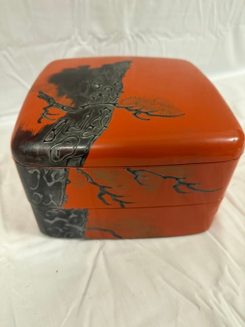 Japanese Lacquerware: Japanese lacquerware box with black bamboo and bird motif on red and orange ground