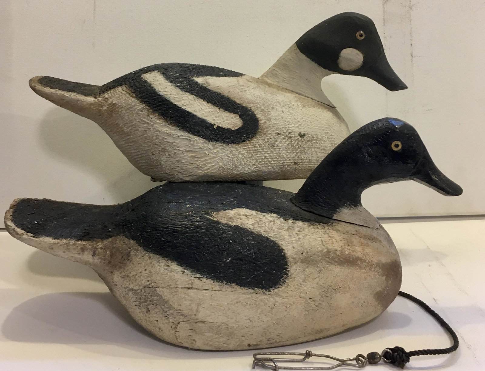Pair of Goldeneyes by Ralph Howlett: Two 15 1/2 inch decoys from the same rig by Ralph Howlett, St. John, New Brunswick, Canada. Rigmates illustrated in Guyette's book- "Decoys of Maritime Canada", on page 176. Old paint with wear from y
