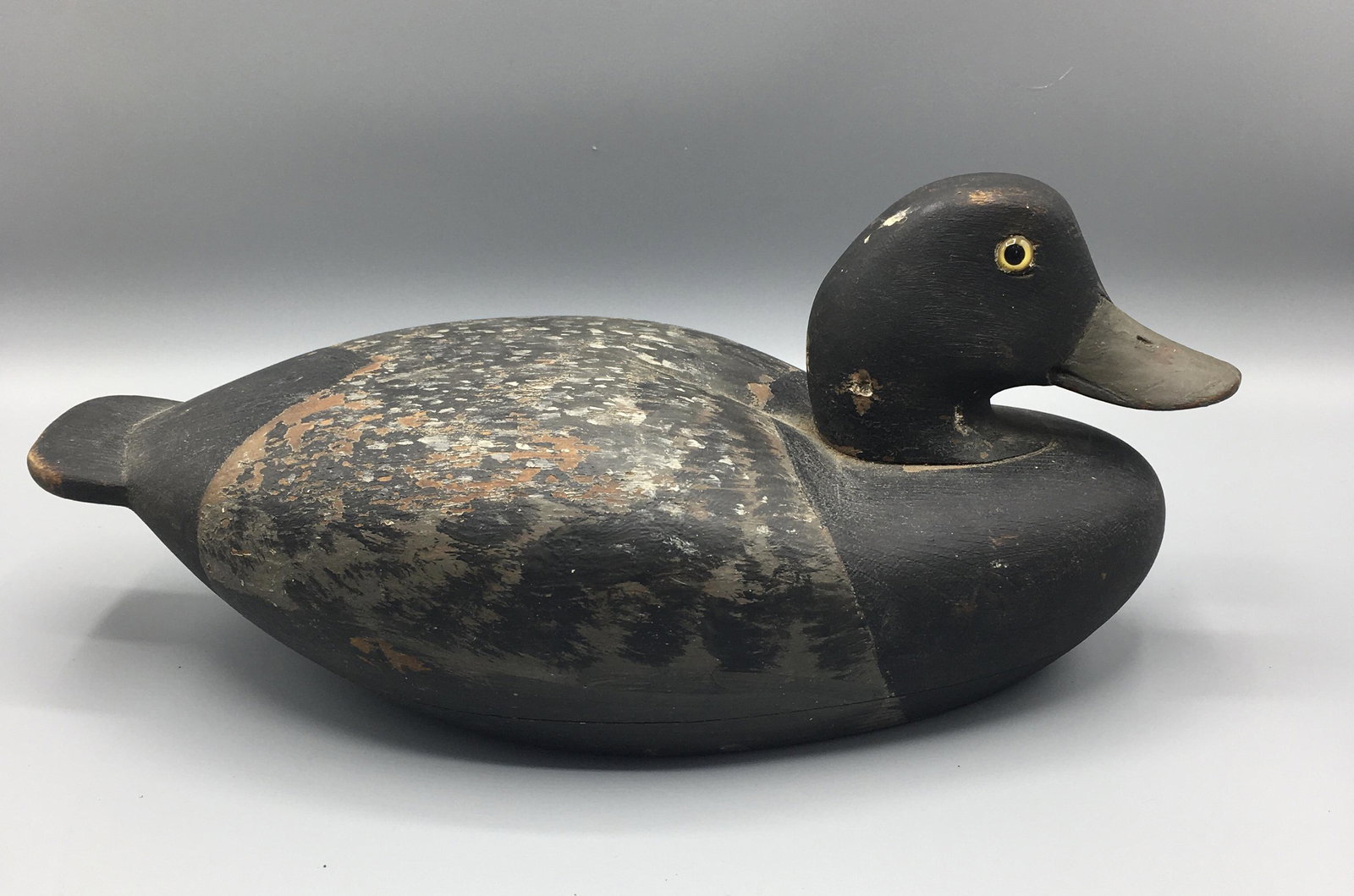 Bluebill Drake from Connecticut: A 12 3/4 inch hollow low head decoy by one of Stratford, Connecticut's fine traditional carvers. In old paint with gunning wear and in use touch-up to the bill.