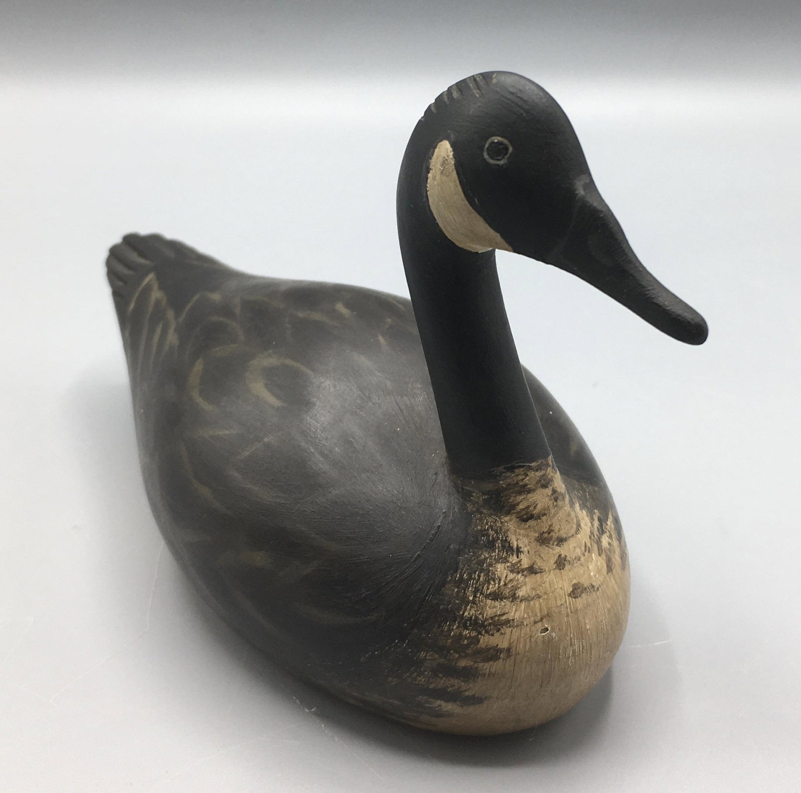 Miniature Canada Goose by Byron E. Bruffee: A 6 3/4 inch miniature Goose carving by Byron Bruffee (1942-2013), Middleboro, MA and Maine. Byron was featured in Emmerling's book "Collecting American Country". Signed with his stamp on the bottom.I