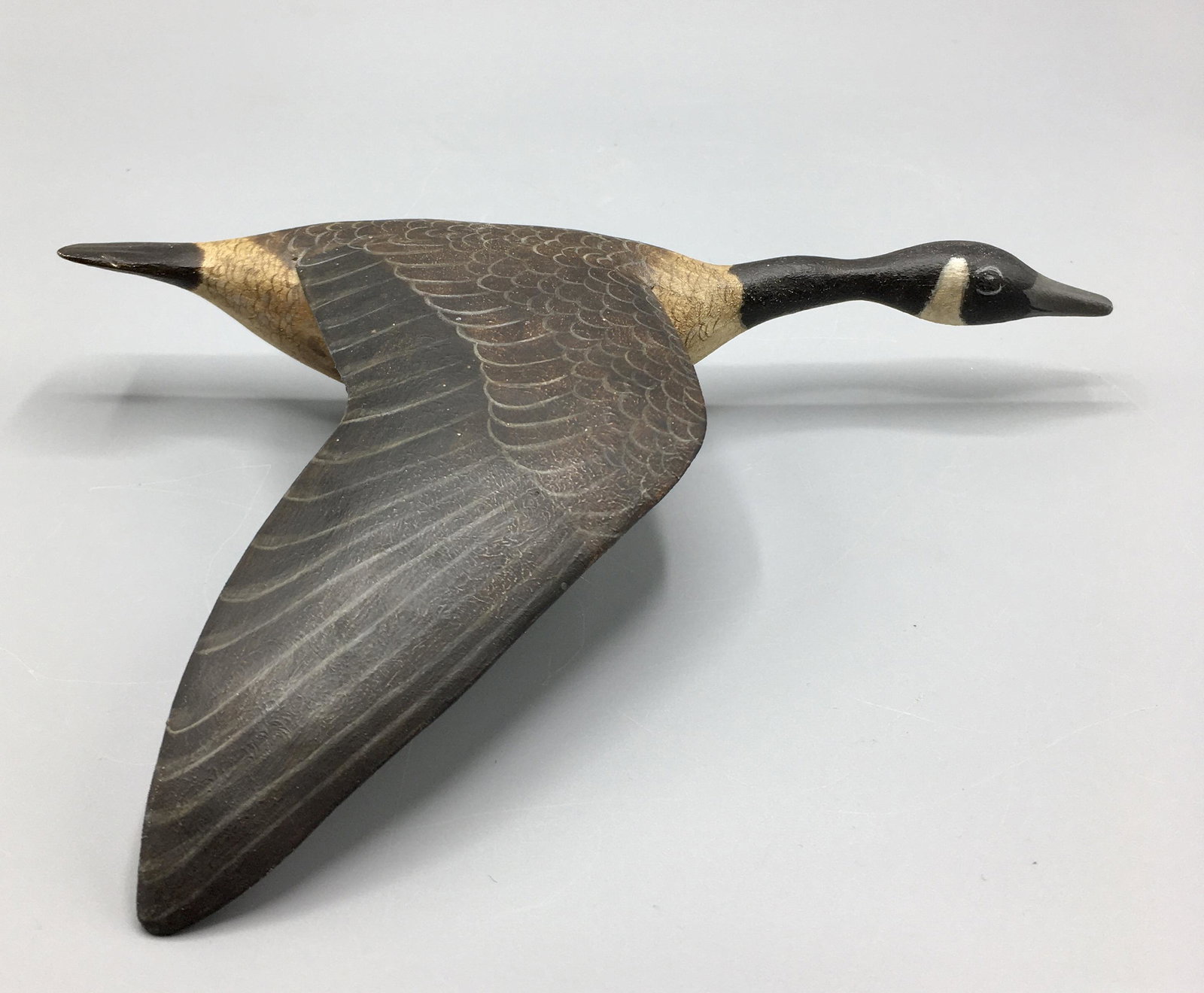 Miniature Canada Goose in Flight by Steve Weaver: An 8 inch miniature one-sided Goose plaque, reflecting the work of Elmer Crowell (1862-1952), a native Cape Codder, like Steve, who became the "Father of Modern American Bird Carving". Signed by the m