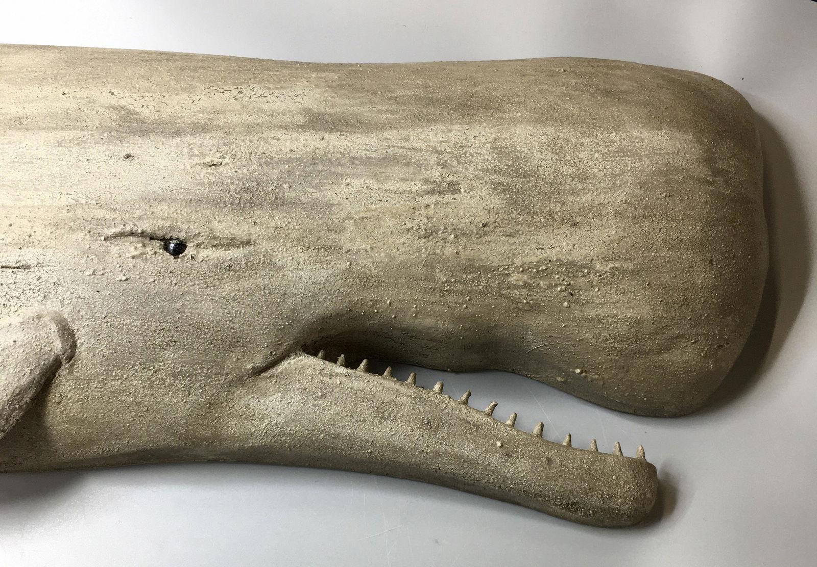 Large Carved White Sperm Whale Plaque: A 10 by 38 by 2 inch hand carved and hand painted white sperm whale plaque by Brian Mitchell of Boone, NC, signed on the back. In original paint with minimal wear.