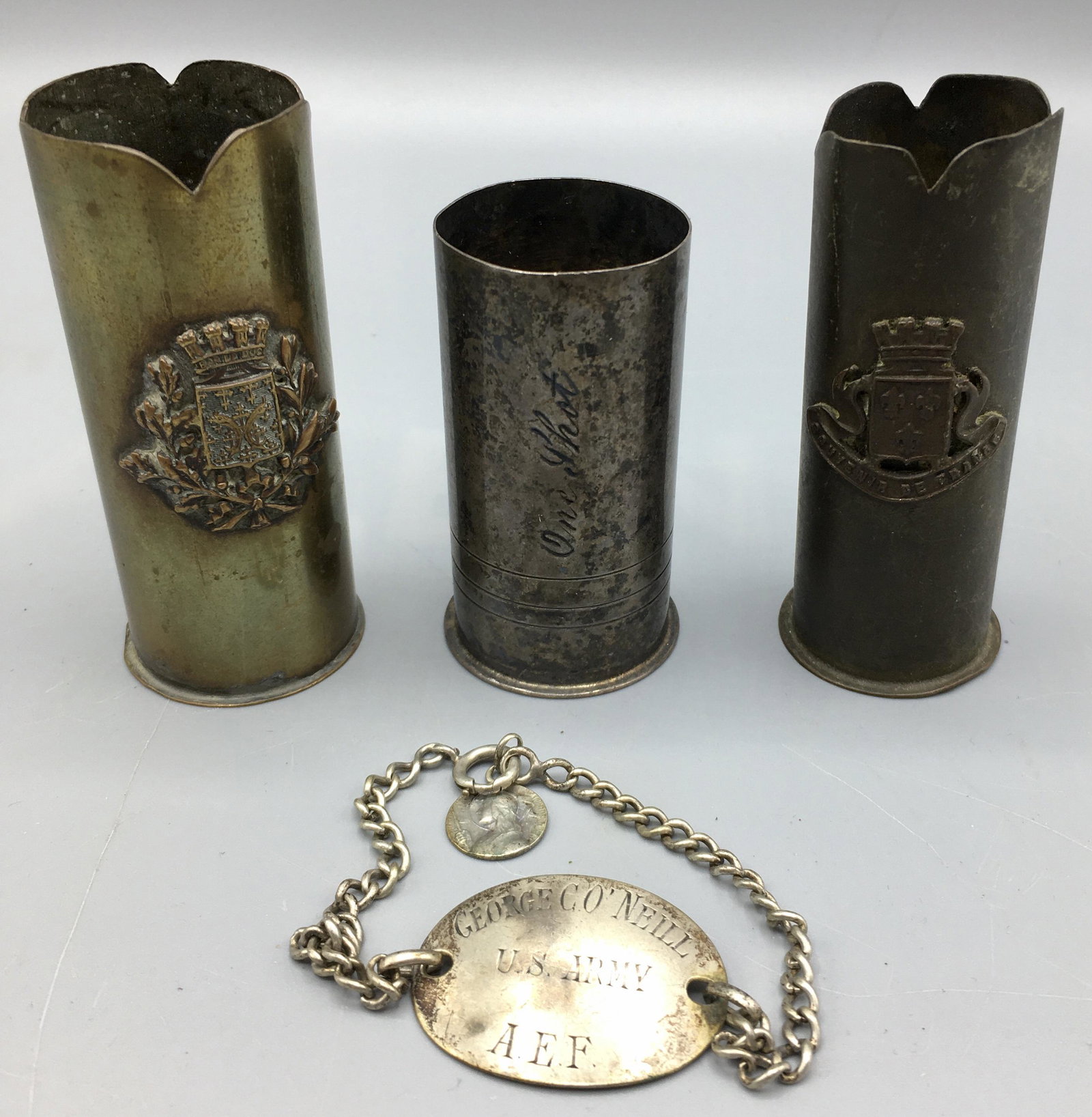 U.S. Army Dog Tag Bracelet WWI A.E.F and Shells: A 1 1/4 inch dog tag on a bracelet from a member of the American Expeditionary Force which was formed in1917 to fight in WWI under General Pershing. Three trench art bullet shell casings, two with app