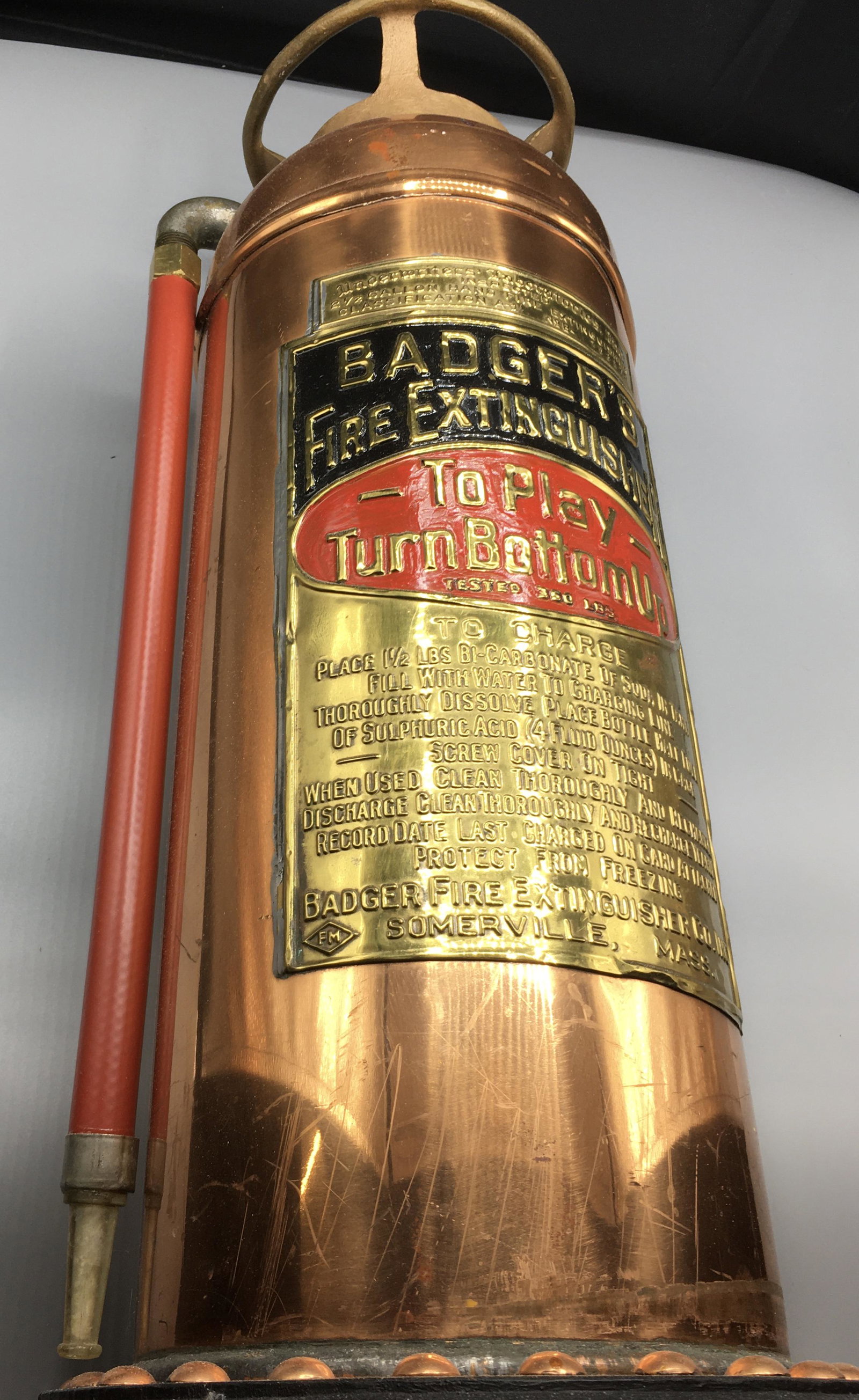 Polished Copper Badger Fire Extinguisher: A 25 by 8 1/2 inch polished copper Badger fire extinguisher. Old fire extinguishers often are made into lamps