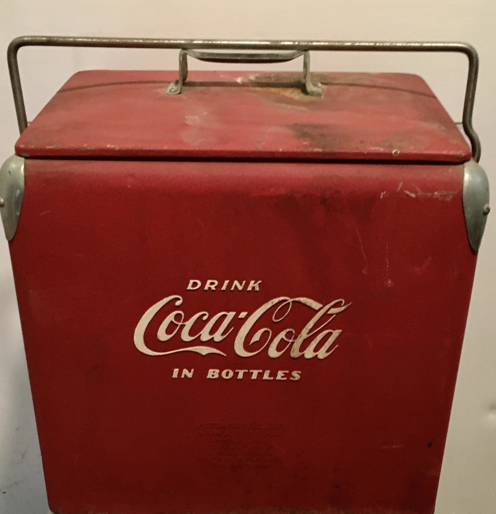 Metal Coca Cola Cooler: A 19 by 17 1/2 by 12 1/2 inch vintage cooler in orignal paint with two metal insert trays and wear.