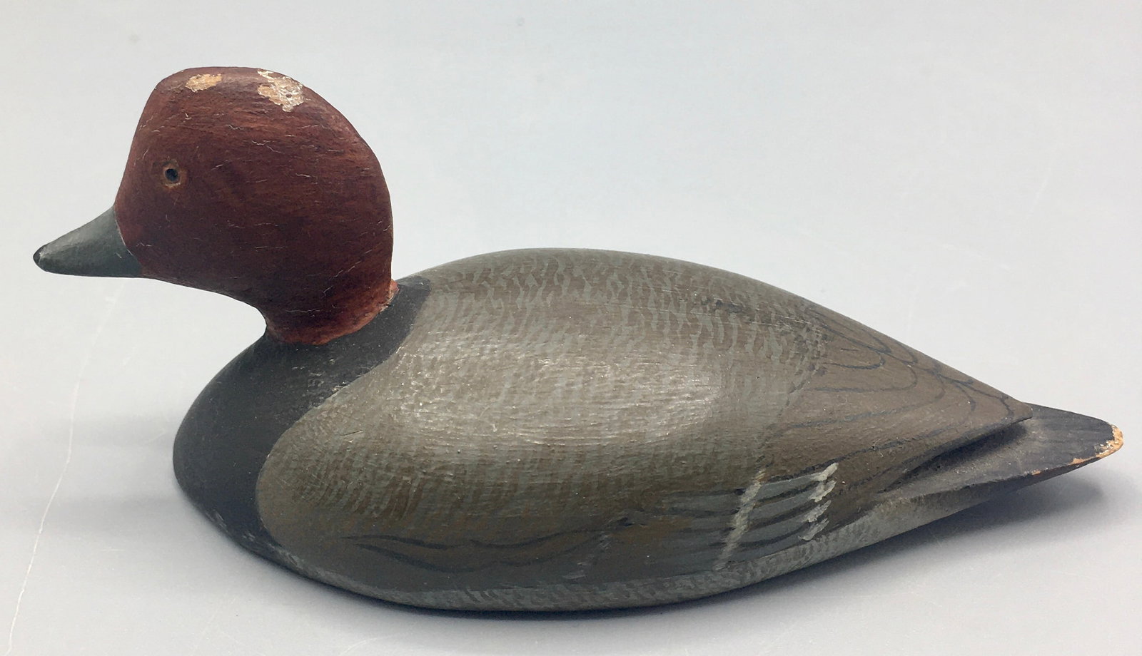 Miniature Redhead Drake Decoy by the Blackstones: A 4 1/2 inch miniature decoy by Jess and his father, Arthur Blackstone when they both lived in Melrose, MA.. This early carving by them displays their early "Seagull, Blaxton" stamp. Original paint wi