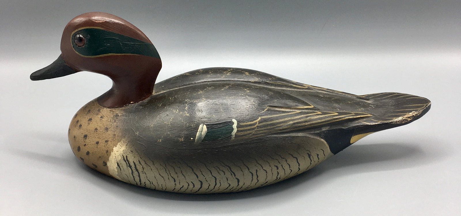 Green-Winged Teal Drake by Wildfowler Decoy Co.: An 11 inch Teal decoy by Wildfowler Decoy Co. (1939-1957), Old Saybrook, CT. This decoy represents the highest grade decoy made at Old Saybrook. Displays raised primary and secondary wing feather grou