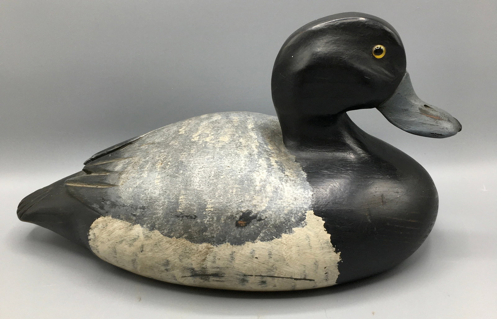 Bluebill Drake by Cedar Bay Decoys: A 12 inch Bluebill or Greater Scaup drake signed Cedar Bay Decoys, with the initials "KM". A superb decoy exhibiting glass eyes, carved bill detail and raised primary feathers.