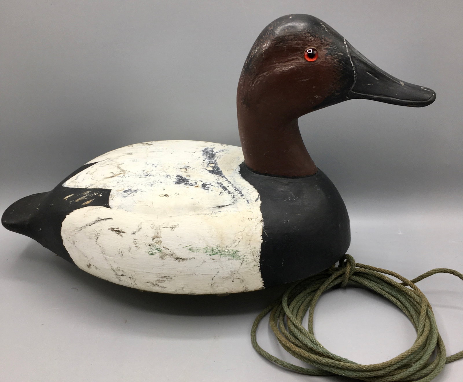 Canvasback Drake Decoy: A 15 inch Canvasback drake decoy with an inserted weight in the keel. Original paint with wear.
