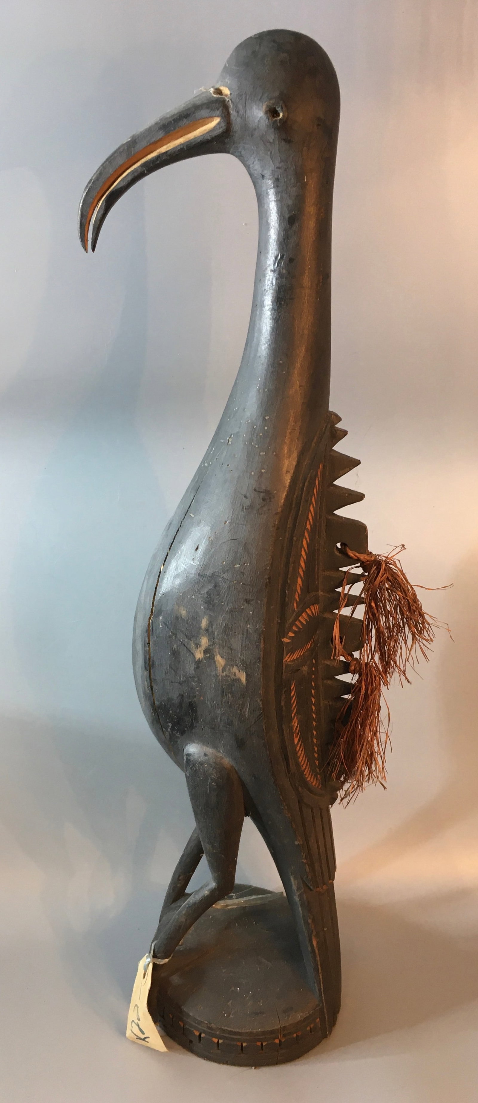 Folk Art Bird from New Guinea: A 24 inch Folk Art bird carving with rope strand feathering detail along the back. Determine condition from the photographs.