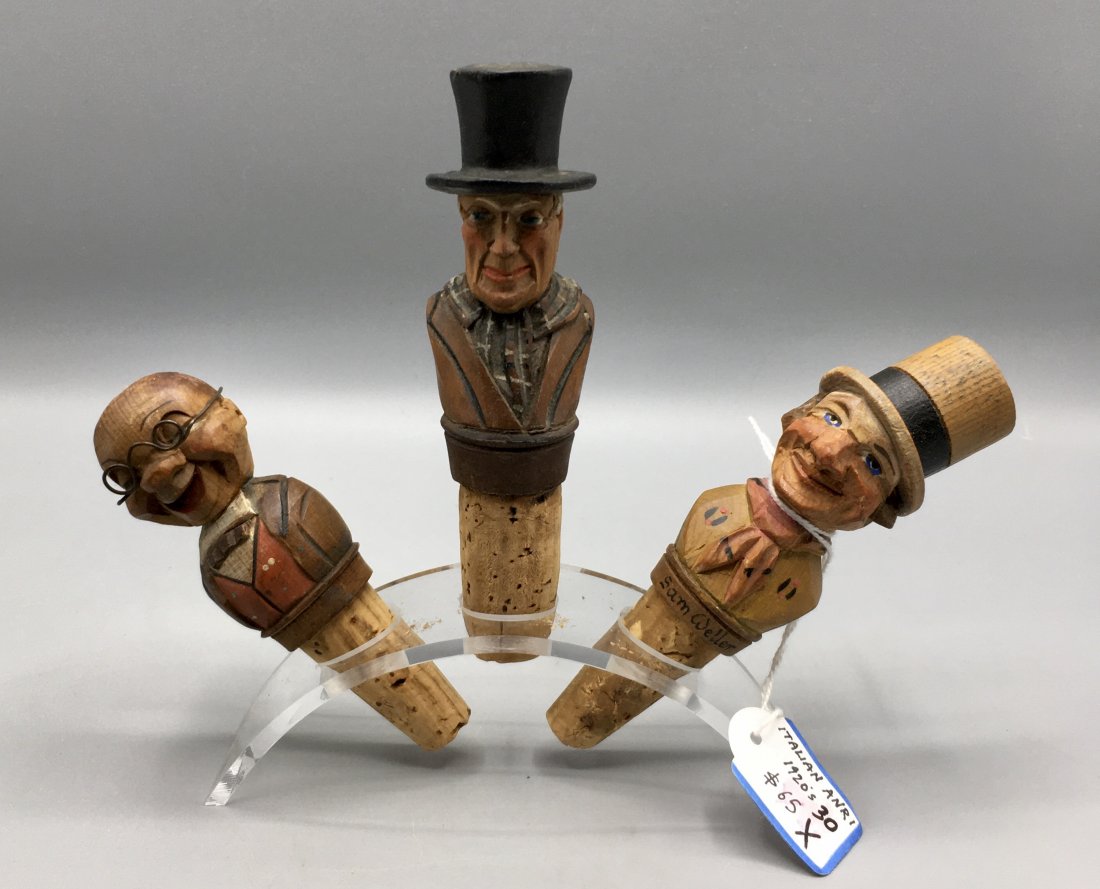 Seven High Quality Bottle Stoppers: Seven 4 to 4 1/2 inch wooden Liquor or Wine Bottle Stoppers, well-carved and painted by European craftsmen. One retains its original price tag "Italian Anri, 1920s. $65.00", another tips his hat., mos
