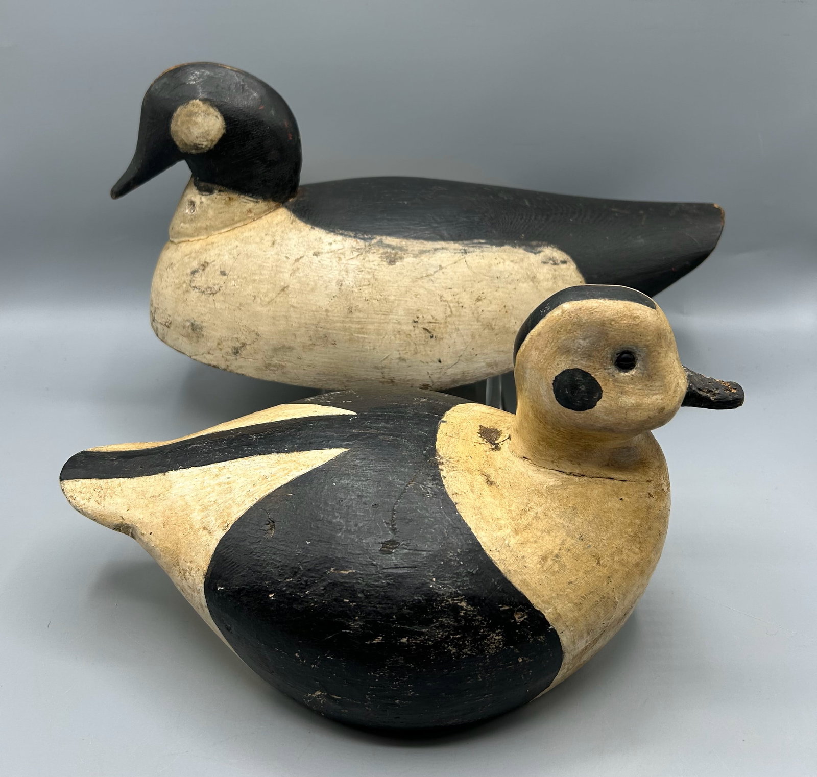 Goldeneye and an Old Squaw from Maine or Canada: A 13 inch Goldeneye drake duck decoy from Coastal Maine or the Canadian Maritimes. A 10 1/2 inch Old Squaw or Long-tailed duck decoy from Maine Both have simple lines that make them reflections of New
