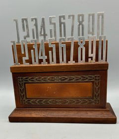 Two Sets of Numbers in a Wooden and Leather Stand