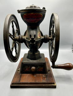 Antique Two Wheel Cast Iron Coffee Mill / Grinder: An 11 by 11 inch cast iron coffee mill / grinder with two 8 1/2 inch wheels and a 10 by 7 inch wooden base by Landers, Frary & Clark (1862-1965), New Britain, CT. In very good original paint and condi