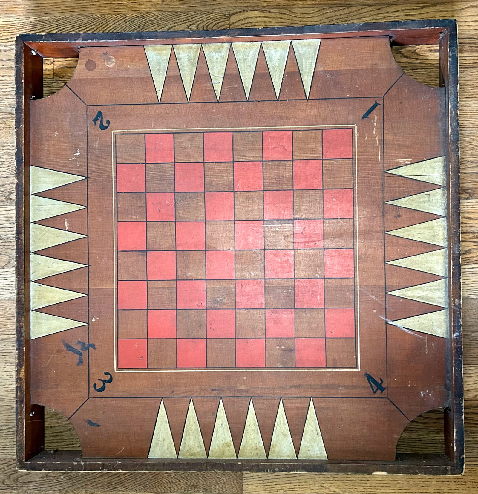 Old Wooden Checkerboard and Carrom Board: A 29 inch wooden game board, on one side is a checkerboard, on the other side is a Carrom board, a game played in the 1700s by Maharajas in India and introduced by Henry Haskell in the U.S. in 1889. A