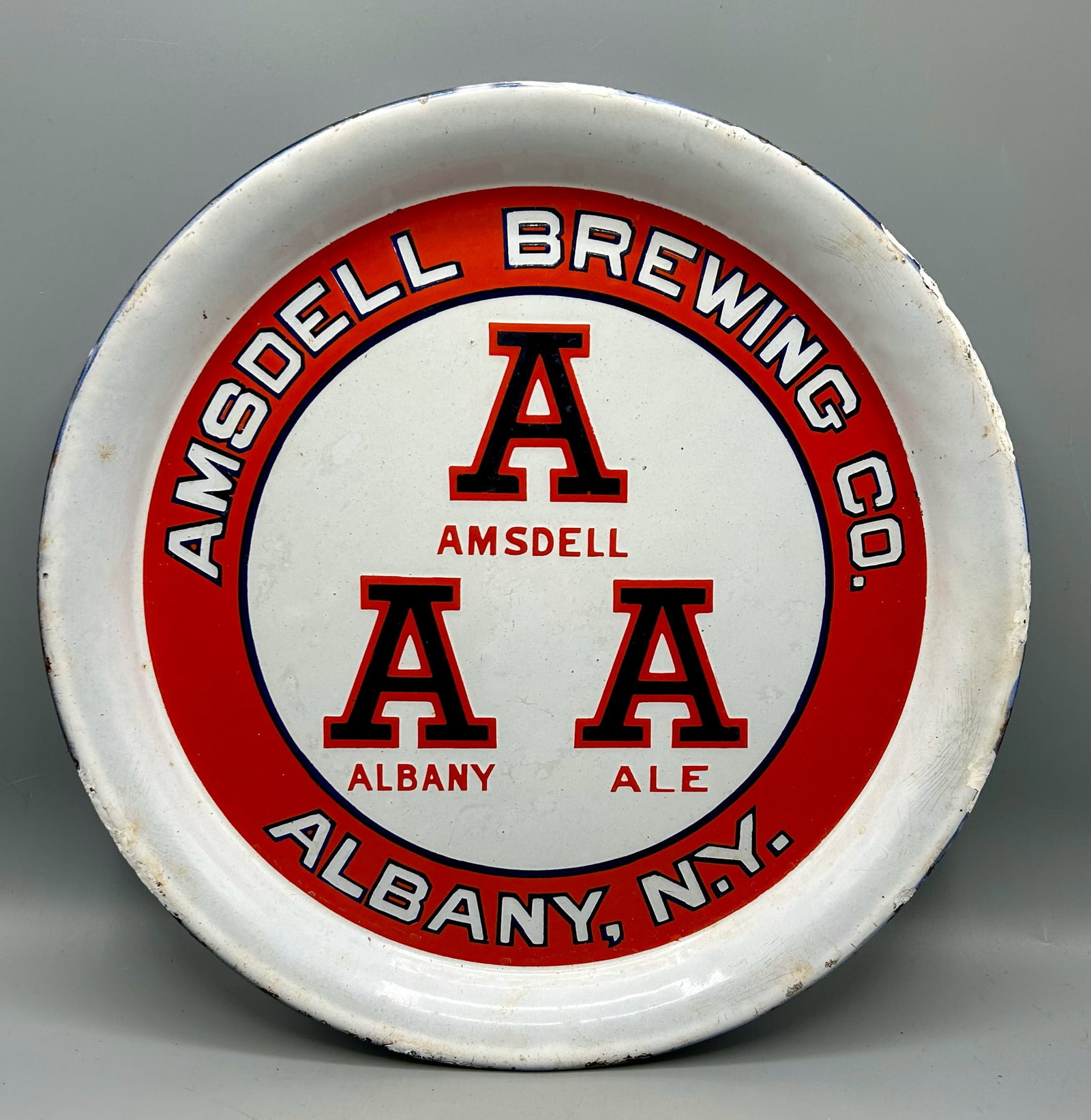 Amsdell Brewing Co. Porcelain on Metal Ad Tray: A 12 inch Amsdell Albany Ale, N.Y. porcelain on metal advertising tray made by the Baltimore Enamel & Novelty Co. (1898-1943), Baltimore, MD and NYC, NY. Condition - as found with damage and touch-up 