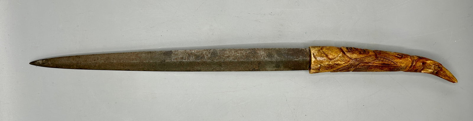 Tribal Knife: A 17 inch knife with a carved bone zoomorphic handle ending in an Eagle head. In as found condition.
