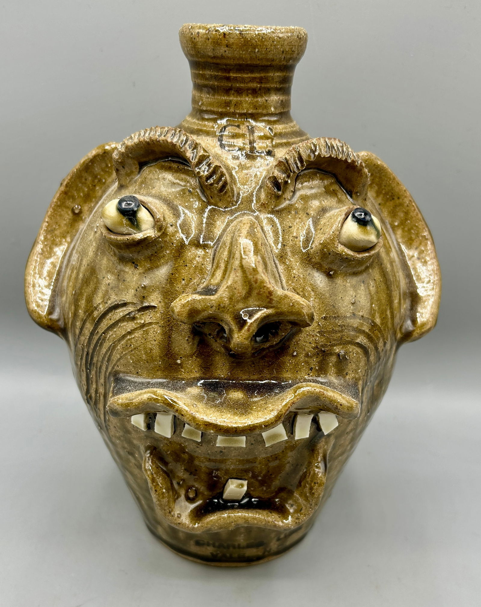 Charles Lisk Screaming Face Jug: Charles Lisk Screaming Face Jug measuring 9 1/4" h Charles Lisk (b. 1952) is a potter from the Catawba Valley tradition in North Carolina. Starting in 1981, Lisk worked under Burlon Craig. Face Jugs a