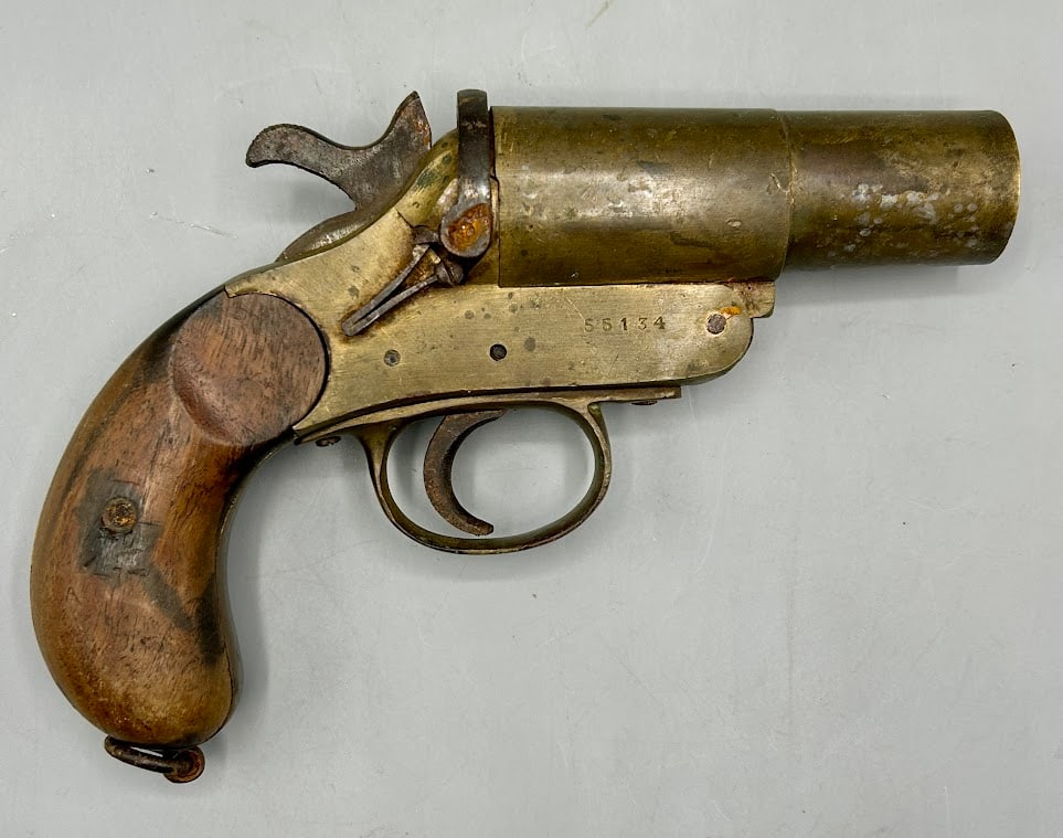 An Antique WWI Era British Brass Naval Flare Gun: An 8 inch World War One era British Brass Naval Flare Gun. One side of the frame has the maker's stamp- Codswell & Harrison in London and the other side bears a serial number. One side of the barrel h