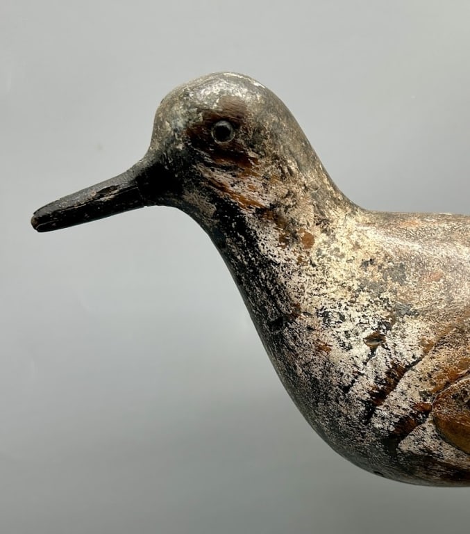 A Documented Shorebird Decoy by John Dilley: A Shorebird decoy by John Dilley, considered one of the finest shorebird makers ever. In old original paint with even wear. In the 1960s this exact decoy was in the collection of Lloyd Johnson (1910-1
