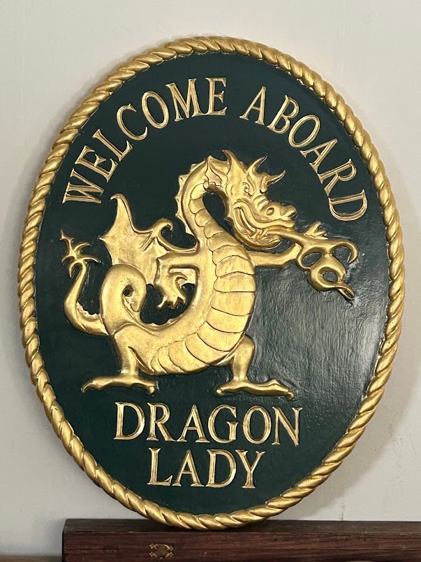 Oval Nautical Welcome Sign for the Yacht Dragon Lady by Amidon: A superb 28 by 22 inch hand carved, 22 kt gold gilded, painted mahogany sign - custom made for the yacht "Dragon Lady" by Douglas Amidon (1944-2024), Sandwich, Cape Cod, MA. The sign exhibits a hand c