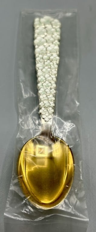 1956 Danish Gilded Sterling Silver & Enamel Spoon: A 6 inch gilded silver spoon with enamel white floral motif by the Anton Michelsen Co, (1841-1985), Copenhagen, Denmark. In 1985 the Company was acquired by the Georg Jensen Company. In excellent cond