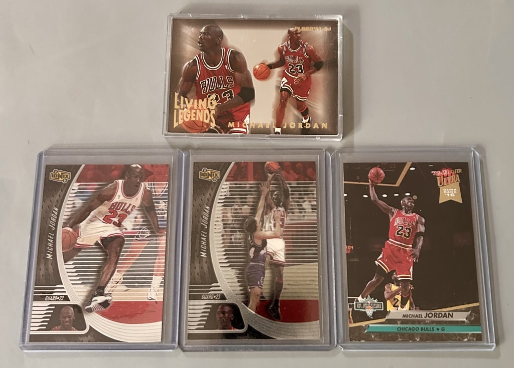 Four Michael Jordan Basketball Cards: Four Chicago Bulls - Michael Jordan basketball cards including a Living Legends card. Judge the grade yourself - this collection of cards have been well cared for.