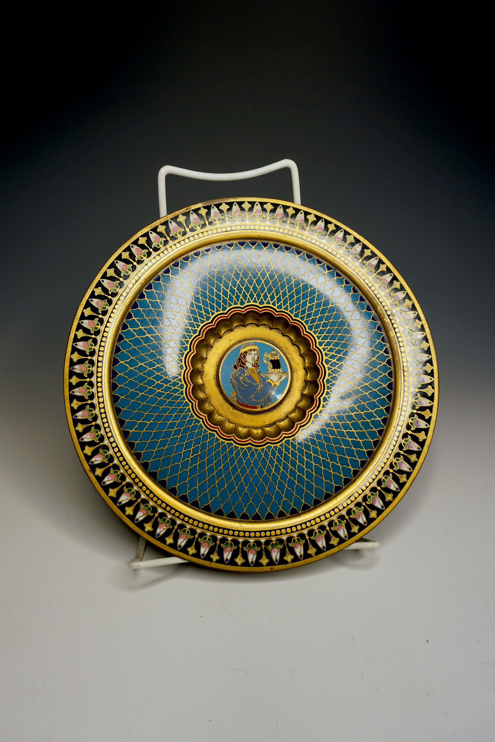 Antique enamel gilt bronze tazza French / Russian: A superbly decorated and finely enameled french or Russian footed enamel tazza. A floral polychrome border surrounds a geometric blue pattern. At the center is a portrait of a figure in historical cos