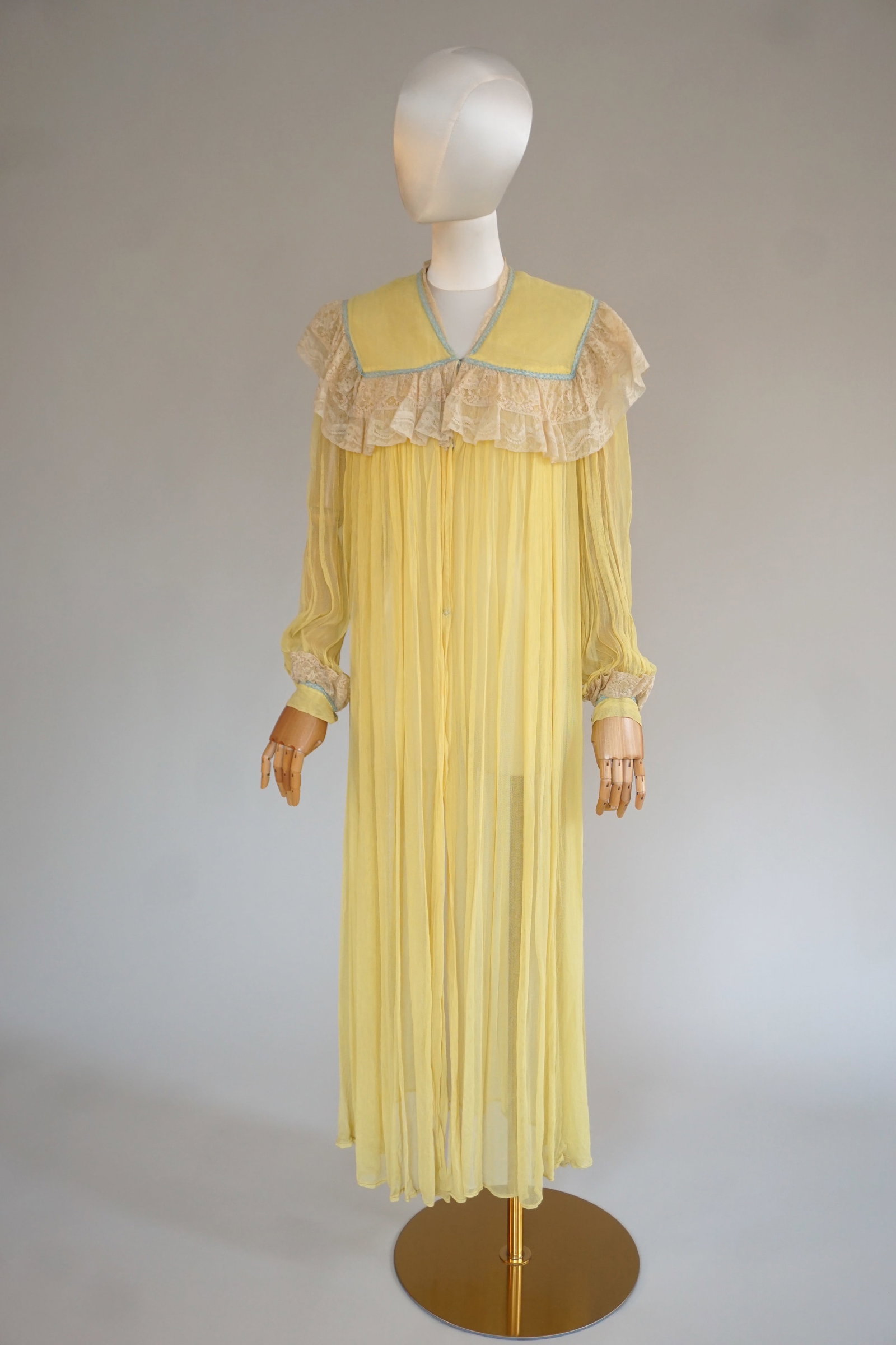 Vintage yellow 1940s boudoir robe with lace: Vintage 1940s yellow semi-sheer robe with blue trim, lace at bust and sleeves. Measures 40" bust, open waist, 18" shoulders across, 53" total length.