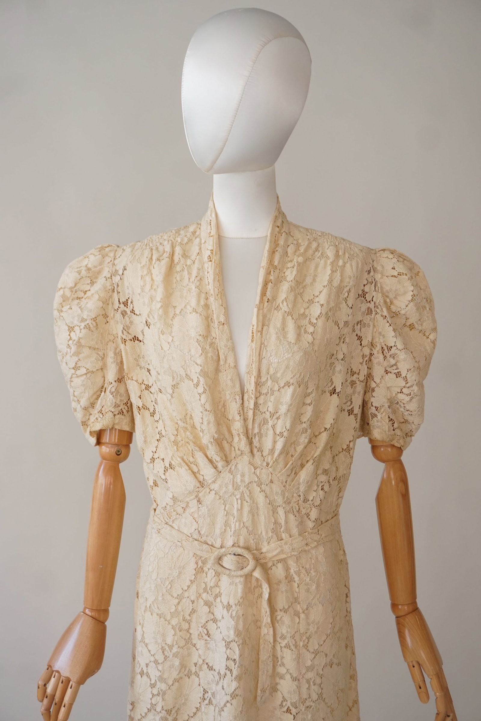 Vintage 1930s 40s ivory lace dress, with label: Vintage 1930s - 40s lace dress with puff sleeves and belt, Label: A Charm Lace Frock. Size L 38" bust, 34" waist.