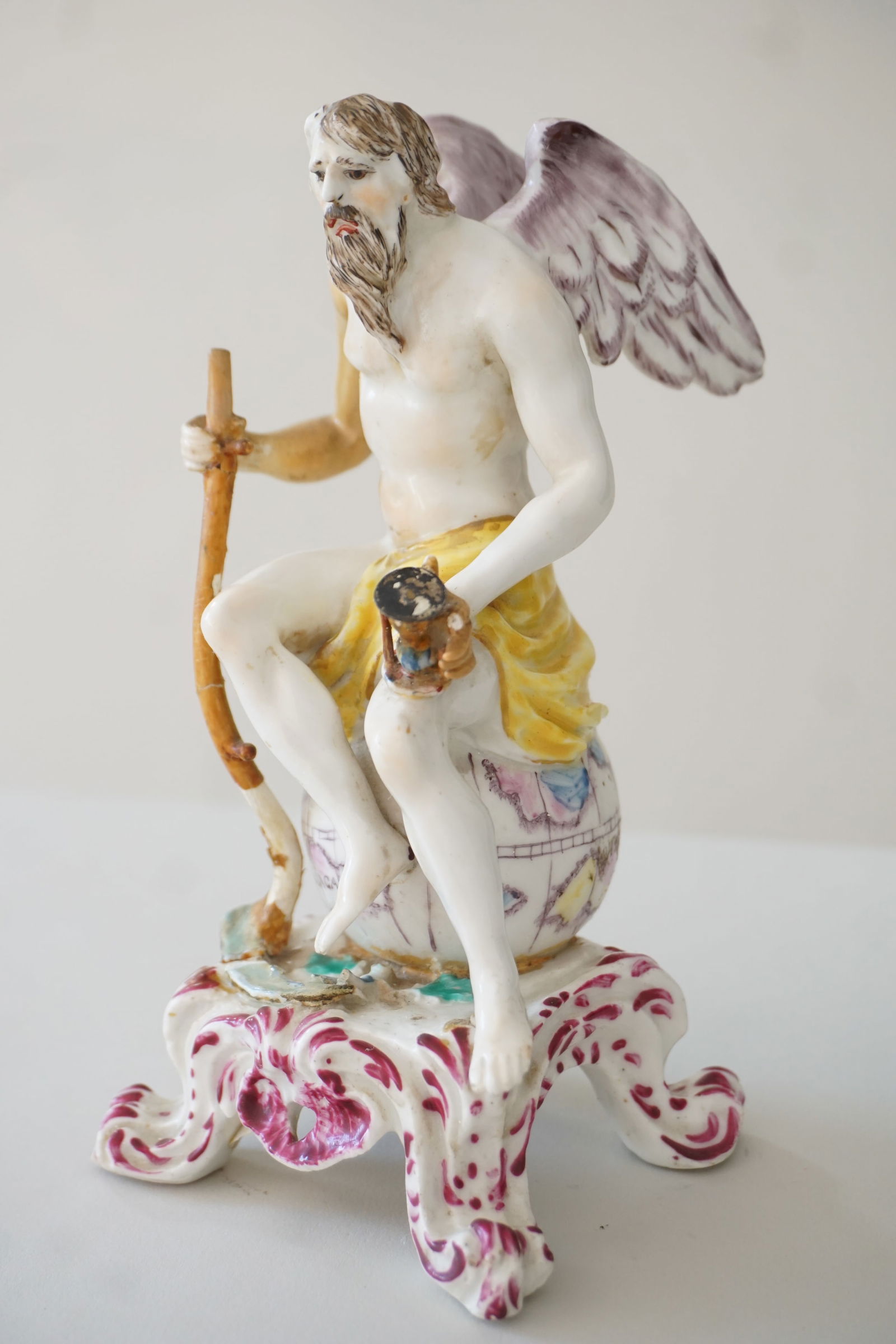 Rare 18th c. Bow porcelain figure of Father Time: Likely executed by Thomas Frye or James Giles. An exquisitely constructed allegorical figure of Father Time seated atop the world with scithe in hand. Curiously, the map depicts Madagascar prominently